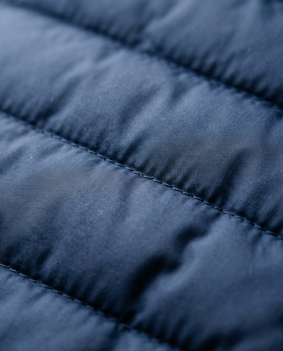 Quilted padded fabric texture of the Padded Bomber Jacket Northern Harbour in navy